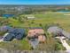 Aerial view of a home with a pool, close to a golf course, trees and a water feature at 20 Promenade At Lionspaw, Daytona Beach, FL 32124