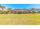 Large backyard with lush green grass and screened in pool overlooking a golf course at 20 Promenade At Lionspaw, Daytona Beach, FL 32124