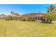 Expansive backyard featuring a screened-in pool and lush landscaping with palm trees at 20 Promenade At Lionspaw, Daytona Beach, FL 32124