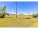 Beautiful backyard view overlooking the golf course with a tall palm tree at 20 Promenade At Lionspaw, Daytona Beach, FL 32124