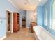 Bright bathroom featuring a soaking tub, dual vanities, a separate wardrobe and an adjacent walk-in closet at 20 Promenade At Lionspaw, Daytona Beach, FL 32124