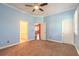 Large bedroom with ensuite bathroom access, fan and neutral tones at 20 Promenade At Lionspaw, Daytona Beach, FL 32124