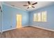 Bright bedroom with plush carpeting, ceiling fan, and a large window for natural light at 20 Promenade At Lionspaw, Daytona Beach, FL 32124