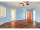 Spacious primary bedroom with hardwood floors, modern ceiling fan, and natural light through the windows at 20 Promenade At Lionspaw, Daytona Beach, FL 32124