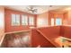 Bright bedroom with hardwood floors, crown molding, three windows with shutters, and a ceiling fan at 20 Promenade At Lionspaw, Daytona Beach, FL 32124