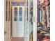 Custom walk-in closet with glass front cabinets, pull-out drawers, and ample clothing storage at 20 Promenade At Lionspaw, Daytona Beach, FL 32124