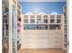Custom walk-in closet with built-in drawers, storage cabinets, rods, and baskets at 20 Promenade At Lionspaw, Daytona Beach, FL 32124