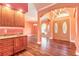 Welcoming entryway with wood floors, custom wet-bar, arched entryways, and double front doors at 20 Promenade At Lionspaw, Daytona Beach, FL 32124