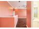 Open hallway with dark wood floors, crown molding, and access to a bathroom with a vanity at 20 Promenade At Lionspaw, Daytona Beach, FL 32124