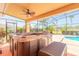 Covered hot tub on a patio with a view of a manicured backyard and golf course at 20 Promenade At Lionspaw, Daytona Beach, FL 32124
