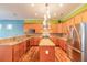 Spacious kitchen with an island, granite countertops, stainless steel appliances, and ample cabinets at 20 Promenade At Lionspaw, Daytona Beach, FL 32124