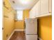 Practical laundry room with washer, dryer, storage cabinets, and a bright, sunny window at 20 Promenade At Lionspaw, Daytona Beach, FL 32124