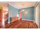 Open living room with wood flooring and a partial view of the kitchen and staircase at 20 Promenade At Lionspaw, Daytona Beach, FL 32124