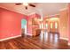 Open-concept living room featuring hardwood floors, wet bar, archways and double door entry at 20 Promenade At Lionspaw, Daytona Beach, FL 32124