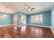 Open-concept living room boasting wood flooring and views of the pool through sliding glass doors at 20 Promenade At Lionspaw, Daytona Beach, FL 32124