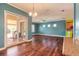 Bright living room featuring wood floors, blue walls, and sliding glass doors to the patio at 20 Promenade At Lionspaw, Daytona Beach, FL 32124