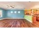 Spacious living room with wood flooring, light blue walls, and a partial view of the kitchen at 20 Promenade At Lionspaw, Daytona Beach, FL 32124