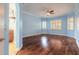 Bright, airy main bedroom with wood floors, large windows, and blue accent wall at 20 Promenade At Lionspaw, Daytona Beach, FL 32124