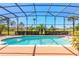 Screened in pool with fountain, surrounded by lush greenery and a golf course at 20 Promenade At Lionspaw, Daytona Beach, FL 32124
