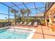 Inviting screened-in pool area featuring sun loungers and lush landscaping for a serene outdoor retreat at 20 Promenade At Lionspaw, Daytona Beach, FL 32124