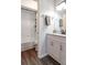 Bathroom featuring white tiled shower and tub, vinyl flooring, white vanity and modern fixtures at 2057 Hillview Circle, Deltona, FL 32738