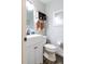 Well-lit bathroom with white vanity, toilet, mirror, and modern fixtures at 2057 Hillview Circle, Deltona, FL 32738