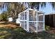 Outdoor chicken coop on a grassy lawn, shaded by mature oak trees at 2057 Hillview Circle, Deltona, FL 32738