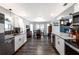 Open concept kitchen with white cabinets, granite countertops, stainless steel appliances, and dining area at 2057 Hillview Circle, Deltona, FL 32738