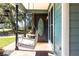 Close-up of the cozy front porch featuring a charming swing and decorative front door at 2057 Hillview Circle, Deltona, FL 32738