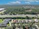 Aerial view of homes with well-maintained lawns surrounded by trees in the background at 212 Stonington Way, Deland, FL 32724
