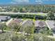 Aerial shot shows home outlined in yellow with lush green backyard at 212 Stonington Way, Deland, FL 32724