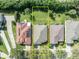Aerial view of the property with a well-maintained lawn surrounded by neighboring homes and greenery at 212 Stonington Way, Deland, FL 32724