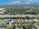 Aerial neighborhood shot; the house marked in red is surrounded by lush greenery at 212 Stonington Way, Deland, FL 32724