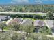 Aerial view of properties with lush landscaping, nestled among mature trees at 212 Stonington Way, Deland, FL 32724