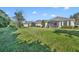 Grassy backyard showing a row of residences with screened patios, offering a serene outdoor living space at 212 Stonington Way, Deland, FL 32724