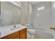 Well-lit bathroom with wood cabinets, a white countertop, and a shower-tub combination at 212 Stonington Way, Deland, FL 32724