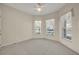 Neutral bedroom with a ceiling fan and multiple windows that provide abundant natural light at 212 Stonington Way, Deland, FL 32724