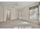 Comfortable bedroom with carpet flooring, ceiling fan, and an open doorway for easy access to other rooms at 212 Stonington Way, Deland, FL 32724