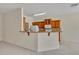 Kitchen breakfast bar with wood cabinets and granite countertops at 212 Stonington Way, Deland, FL 32724