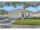 Charming single-story home with a well-manicured lawn and a two-car garage at 212 Stonington Way, Deland, FL 32724