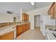 Bright kitchen features granite counters, a breakfast bar, light cabinets, tile flooring and modern appliances at 212 Stonington Way, Deland, FL 32724