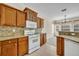 Updated kitchen featuring granite countertops, tile flooring, gas range and view into living and dining spaces at 212 Stonington Way, Deland, FL 32724