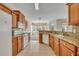 Spacious kitchen with granite countertops, tile flooring and wood cabinets with a view to the dining area at 212 Stonington Way, Deland, FL 32724