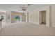 Bright living room with neutral carpet, ceiling fan, and access to the backyard at 212 Stonington Way, Deland, FL 32724