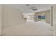 Open living room with neutral carpet and a ceiling fan, adjacent to a breakfast bar at 212 Stonington Way, Deland, FL 32724