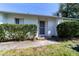 Inviting front entrance of a one-story home with lush greenery and a concrete walkway at 2144 E Parkton Dr, Deltona, FL 32725