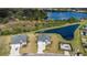 Stunning aerial view of a well-maintained home next to a lake with lush landscaping at 2236 Oconnel Dr, Ormond Beach, FL 32174