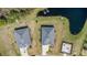 Stunning aerial shot capturing two homes, lush landscaping, and serene pond views in a desirable neighborhood at 2236 Oconnel Dr, Ormond Beach, FL 32174