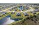 Expansive aerial view of a planned community featuring single-Gathering homes, ponds, and lush landscaping at 2236 Oconnel Dr, Ormond Beach, FL 32174