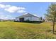 Back exterior view of a single-story home with a spacious backyard at 2236 Oconnel Dr, Ormond Beach, FL 32174